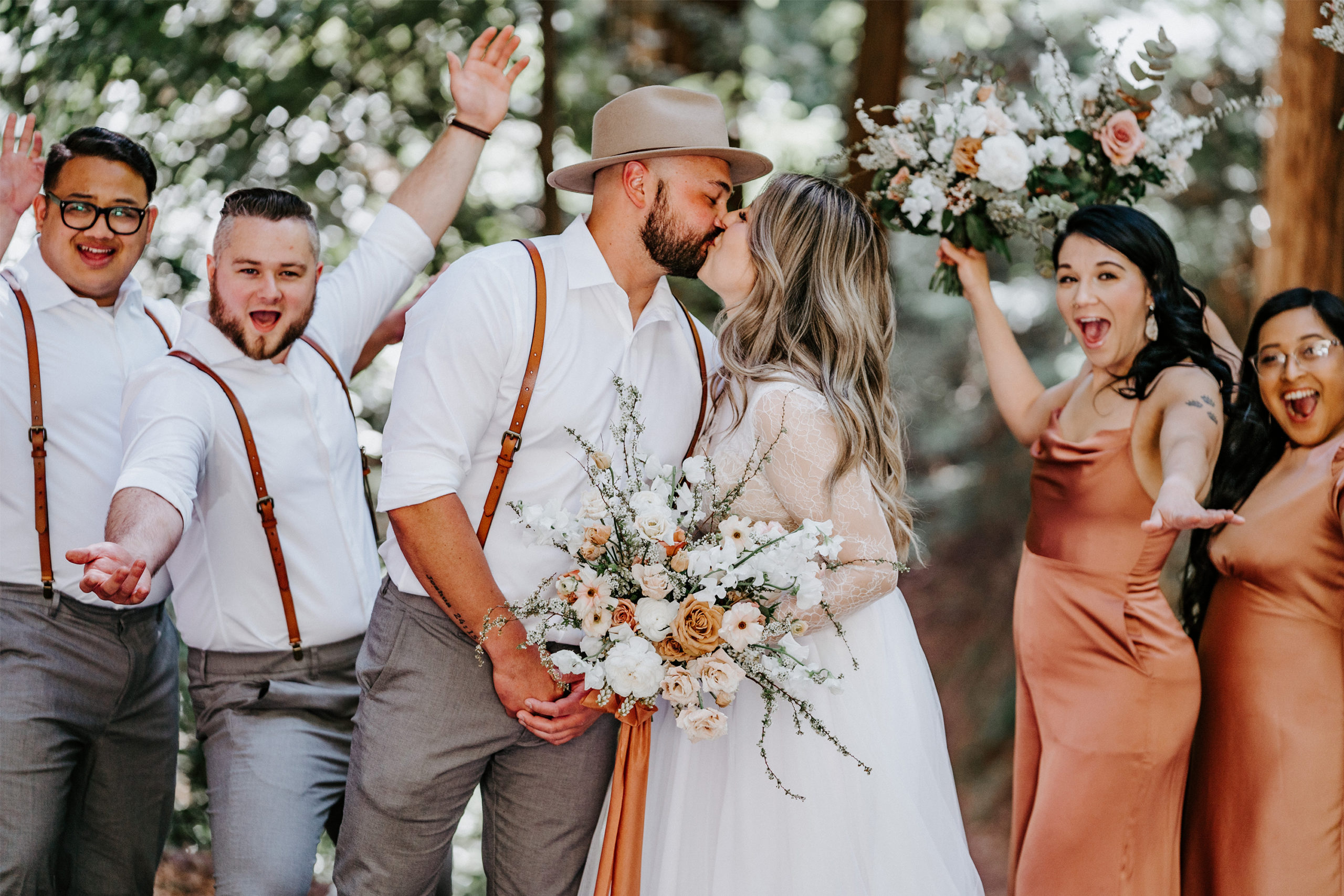 Bride-Groom-Kiss-Wedding-Party-Cheers