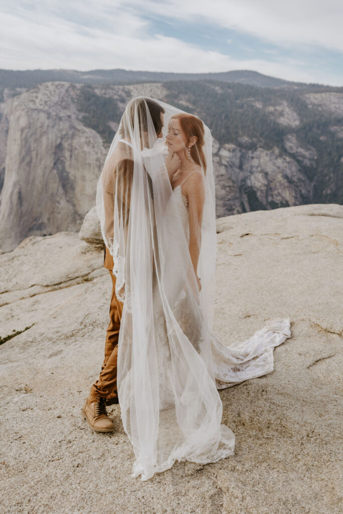 couple at Taft point on wedding day in Yosemite