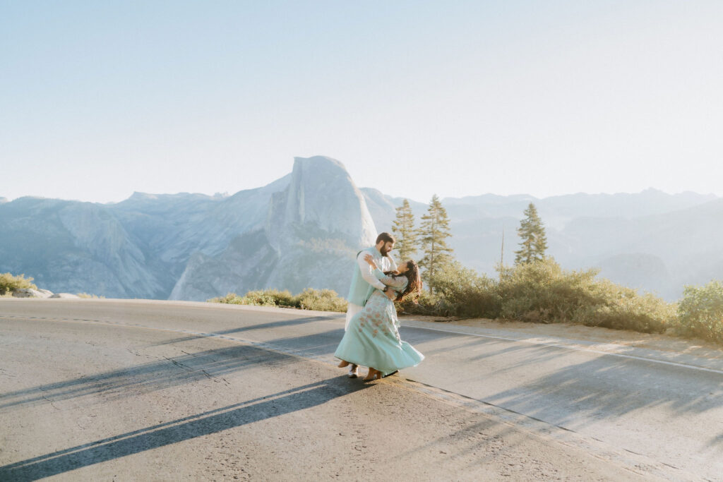 couple dancing in the road on elopement day in yosemite at Glacier Point Road