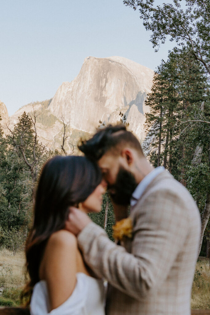 Groom, kissing the bride on the forehead