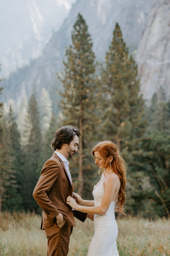 Couple getting ready before wedding in El Capitan Meadow in Yosemite National Park