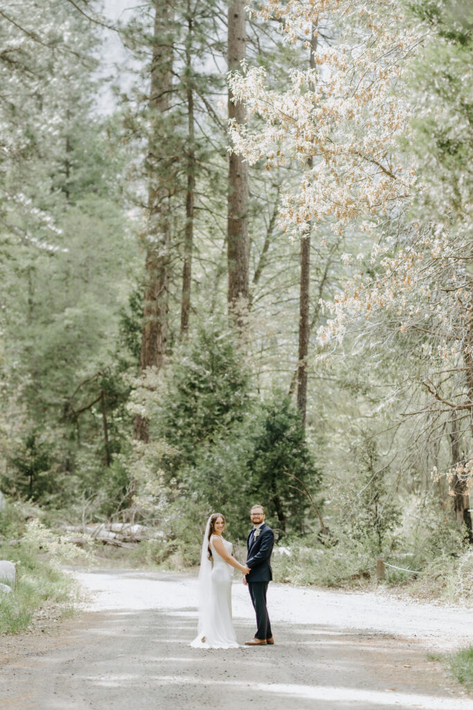 Newly married couple smiling at the camera during their photo shoot