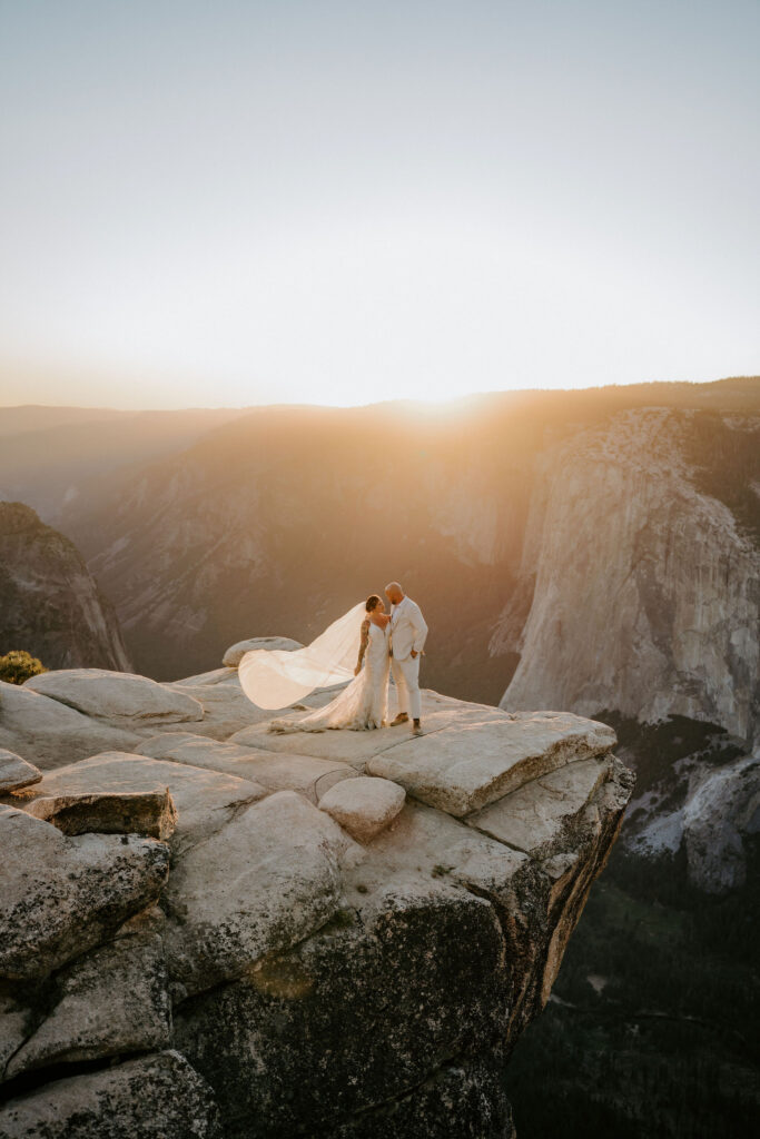 groom kissing the bride on the cheek