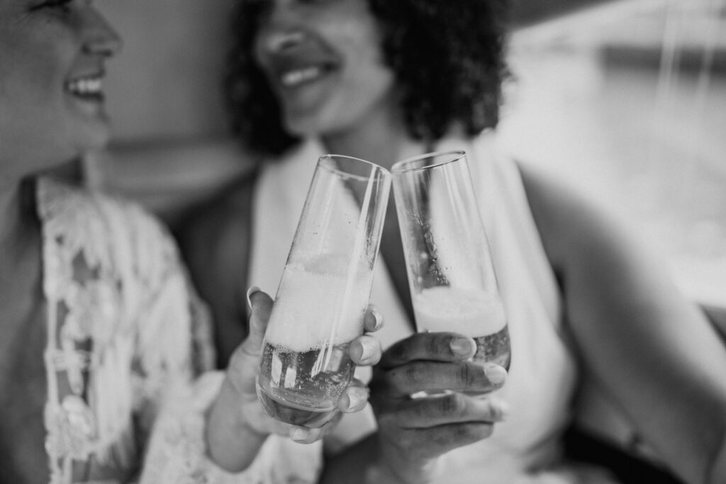 black and white of couple toasting in a seaplane