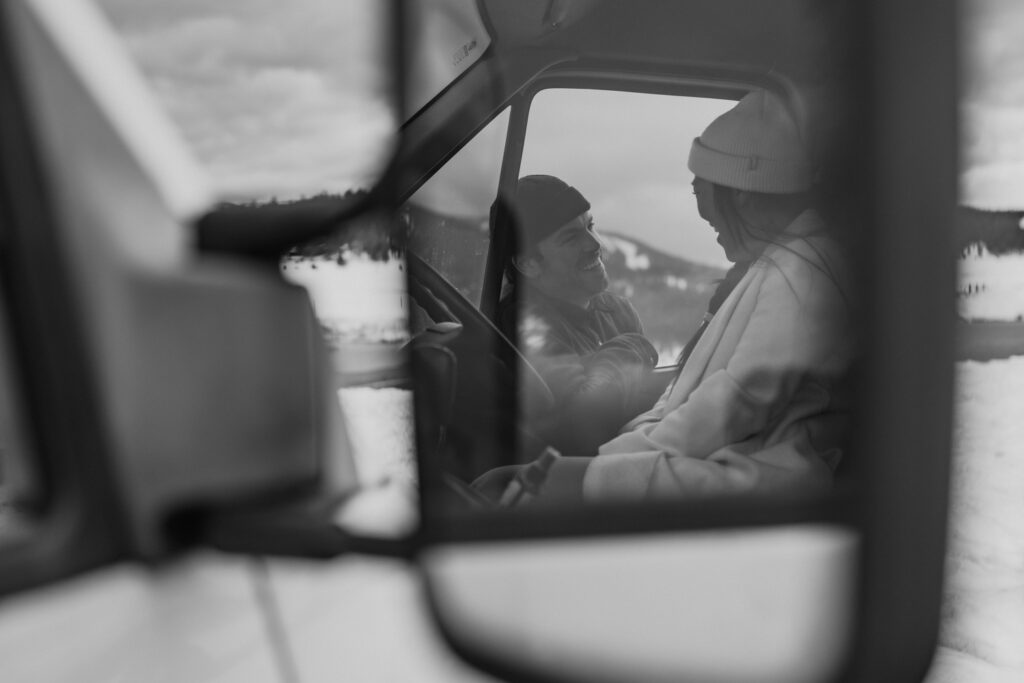 adventure couple in their van sharing a laugh