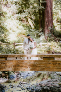 couple standing on bridge during redwood elopement