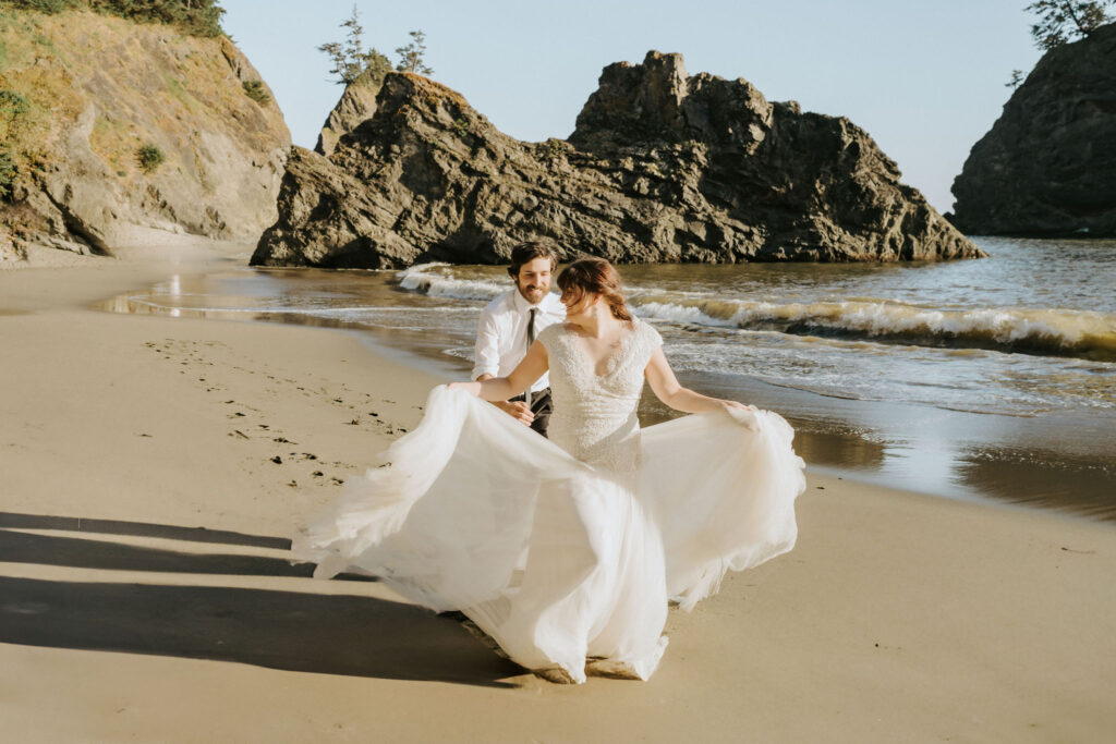 couple running on beach after redwood elopement