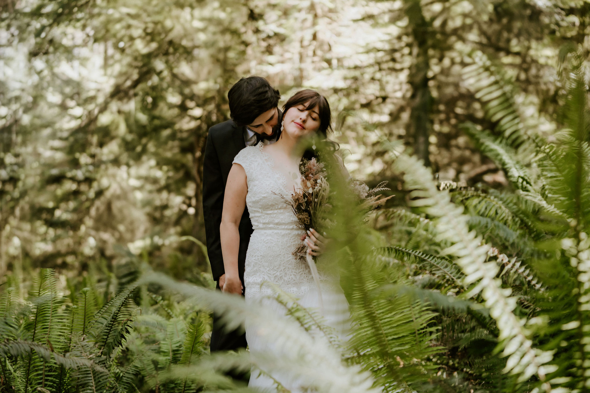 Couple eloping in the Redwoods standing among the ferns