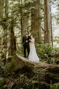 couple standing tall among the redwoods during elopement in California Redwood National Park