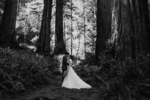 black and white of couple among the redwood ferns