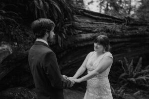 black and white of couple eloping in the redwoods