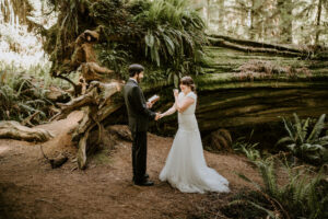 couple laughing during elopement ceremony in the California Redwoods