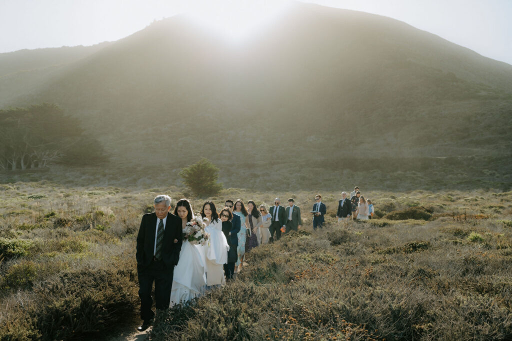 family walking to elopemnent ceremony in big sur at garrapata park