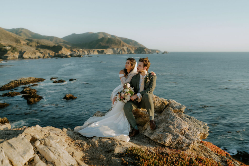 couple on big sur coastline at sunset rocky point
