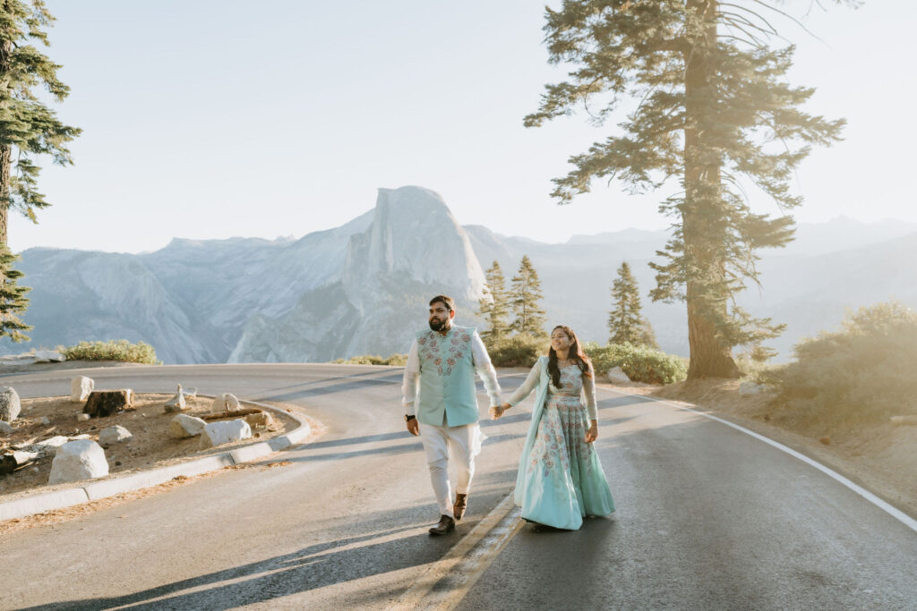 eloping couple walking Glacier Point road in yosemite