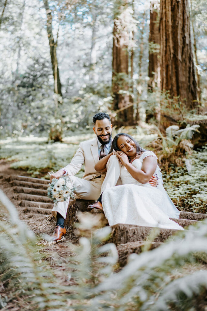 couple smiling and posing after elopement in muir woods california redwoods