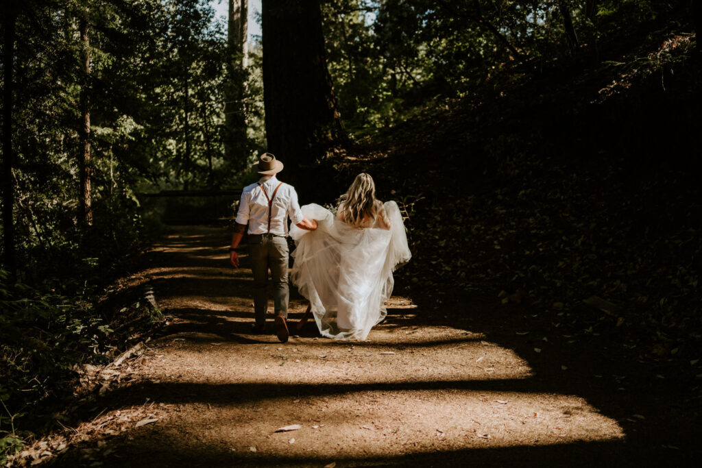 california redwood elopement bride and groom walking in the forest