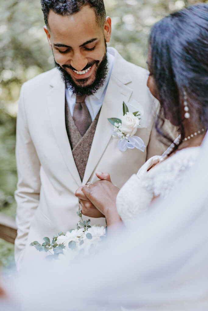 couple looking down at wedding rings