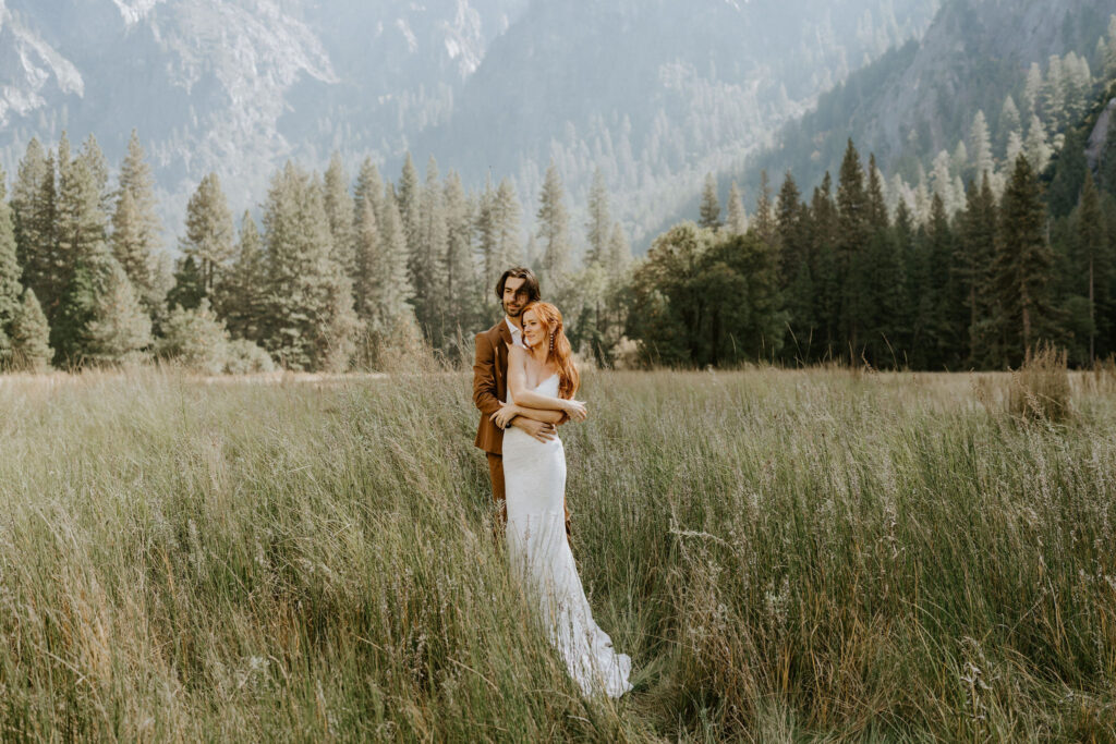 eloping couple standing in El Capitan Meadow in Yosemite