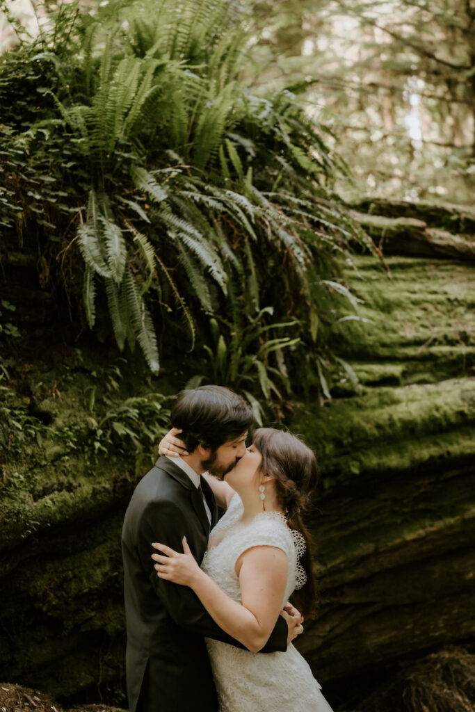 bride and groom first kiss at redwood elopement