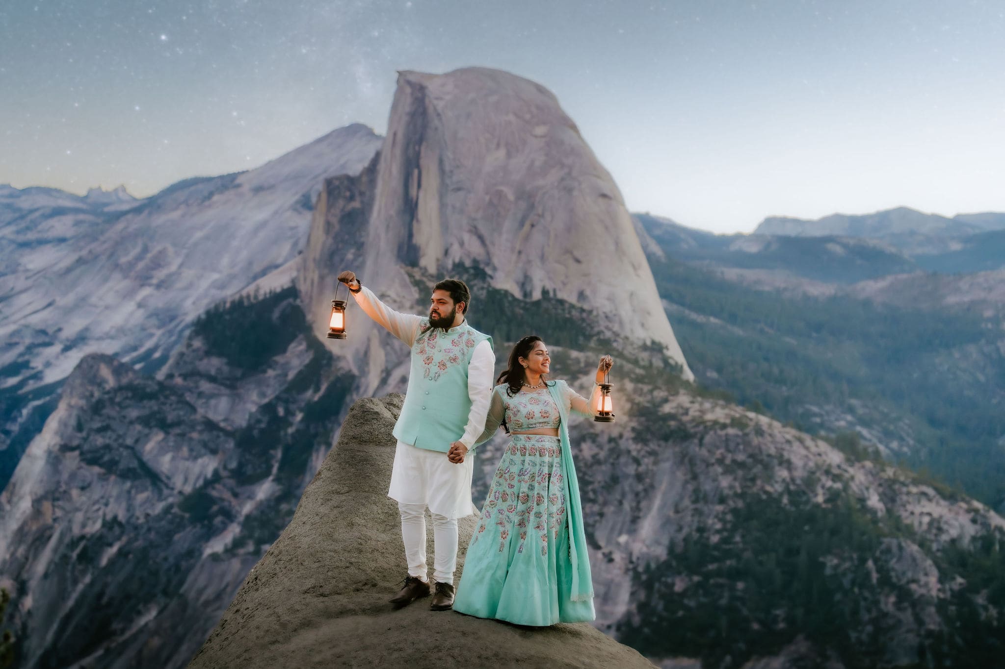 Glacier Point elopement couple taking star photos at sunrise holding lanterns