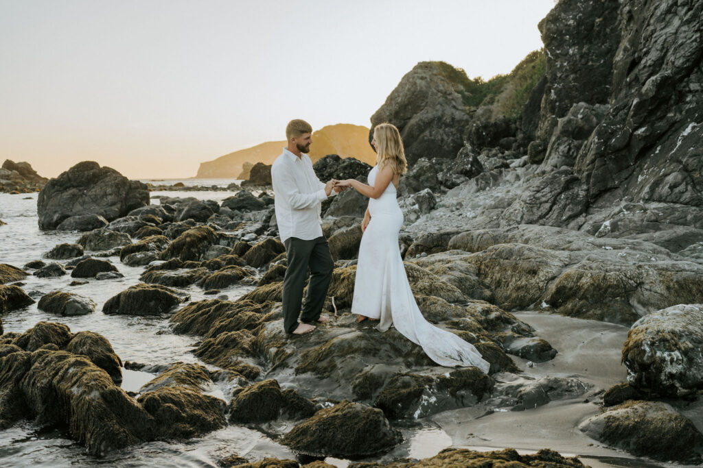 adventure elopement couple exchanging vows near the tide pools on Oregon Coast beach