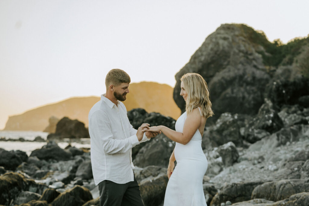 bride and groom exchanging rings during elopement ceremony on Oregon Beach