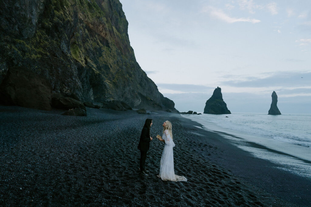 couple eloping on black sand beach in iceland