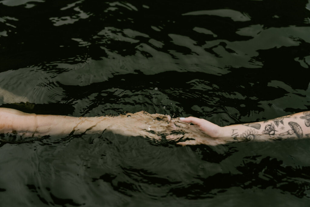 hands in the water at Seljavallalaug