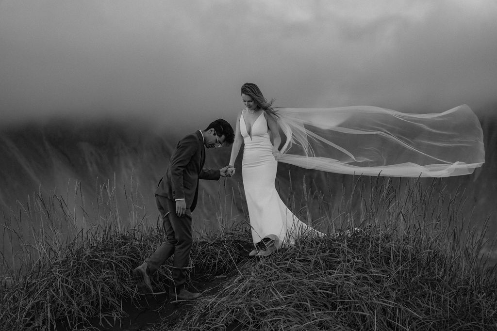 Stokksnes in black and white with elopement couple walking down dune