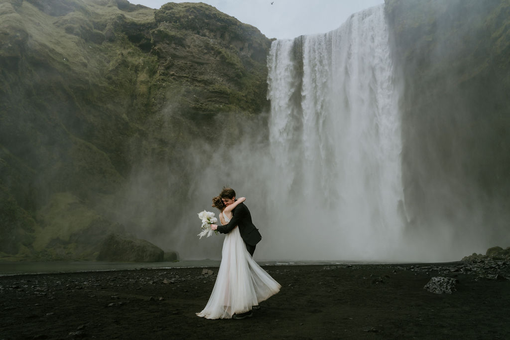 couple getting married in iceland in front of skogafoss waterfall