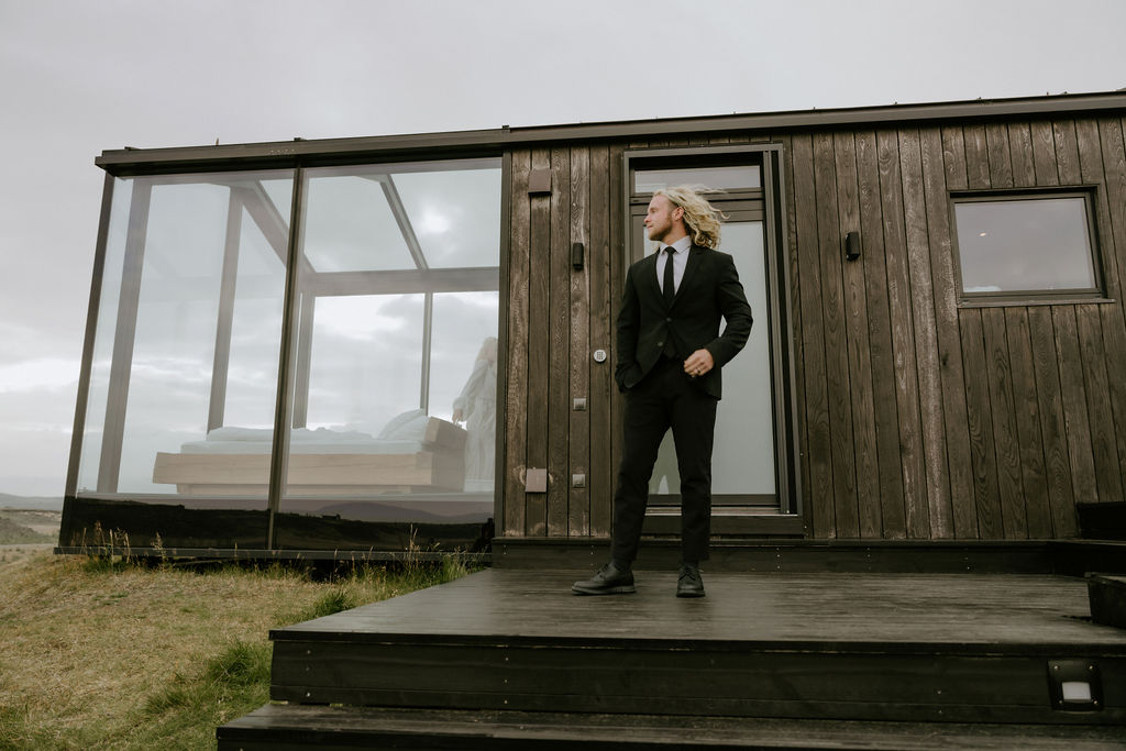 panorama glass house getting ready moments of bride and groom on elopement day in iceland