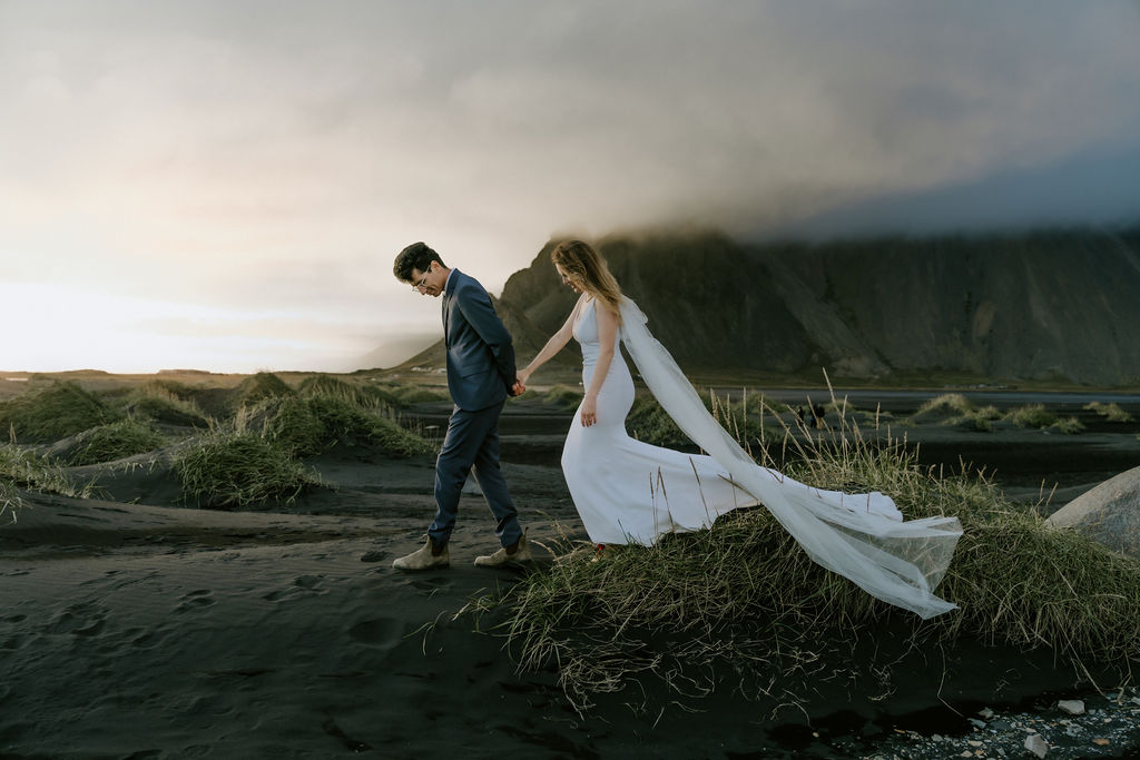 couple walking at sunset in Stokksnes