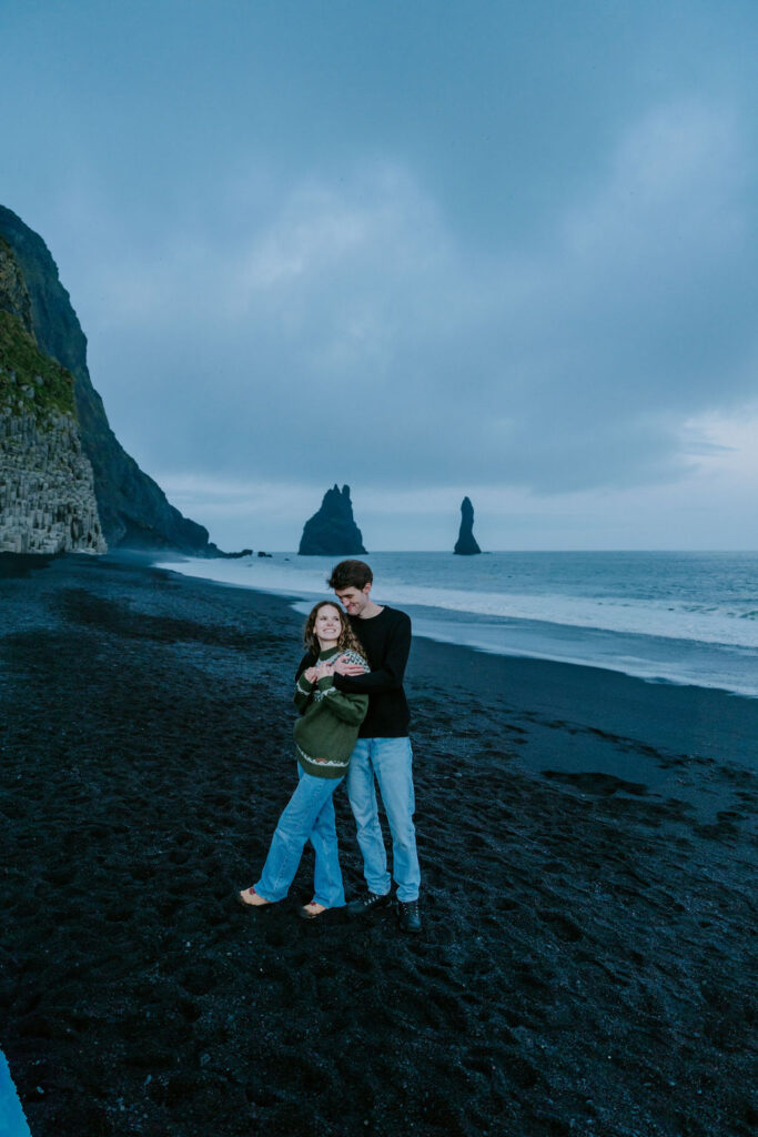 couple standing on Reynisfjara black sand beach after iceland elopement