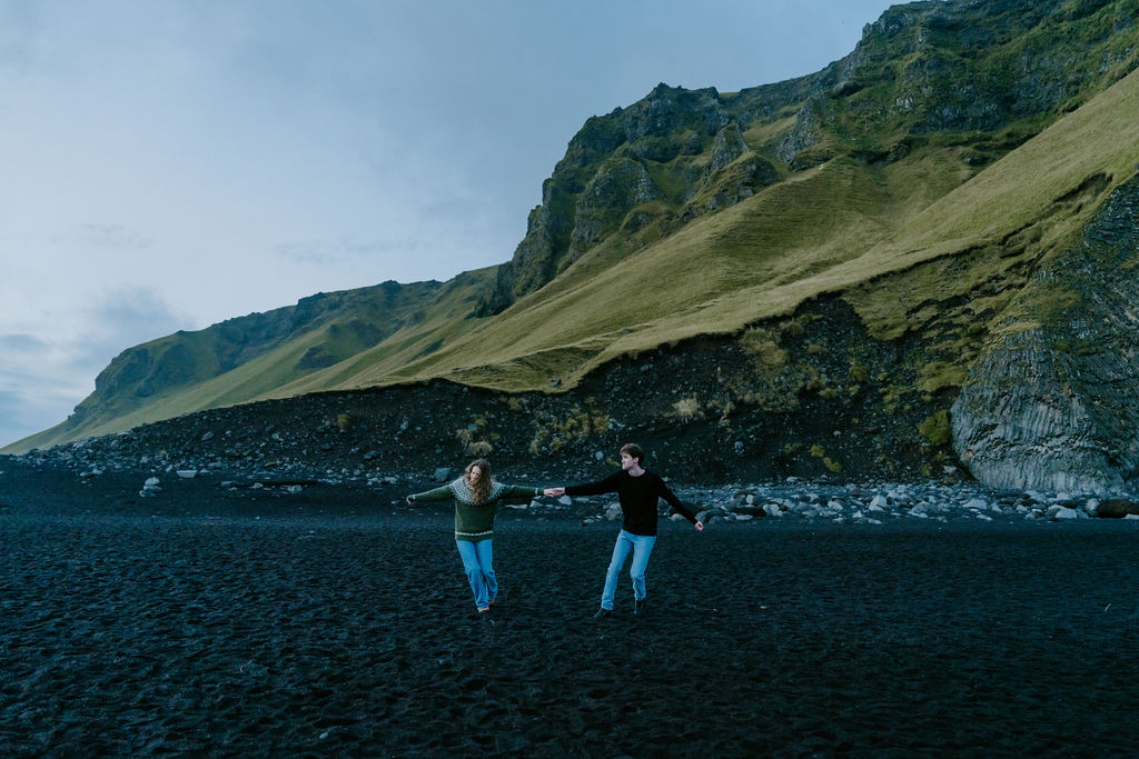 couple running on Reynisfjara while eloping in iceland