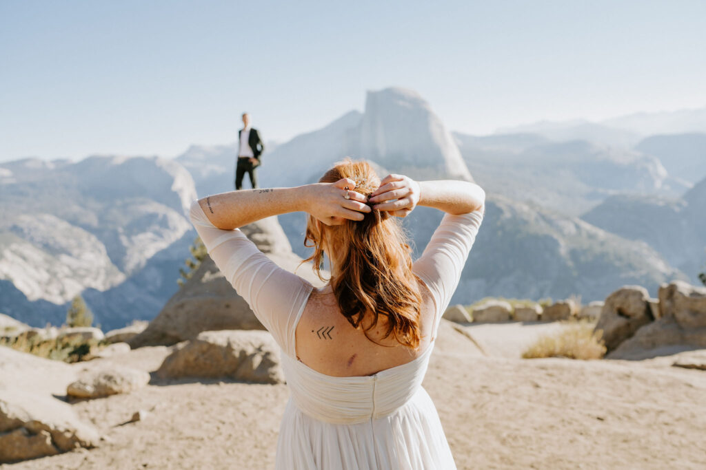 Bride looking on at groom in Yosemite