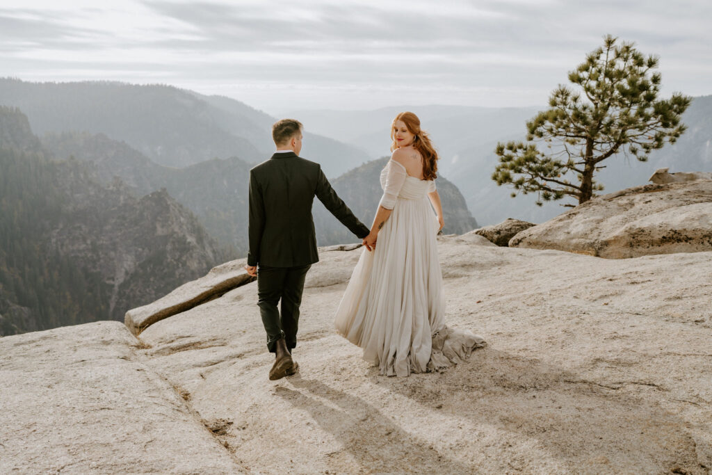 eloping couple walking out to Taft Point