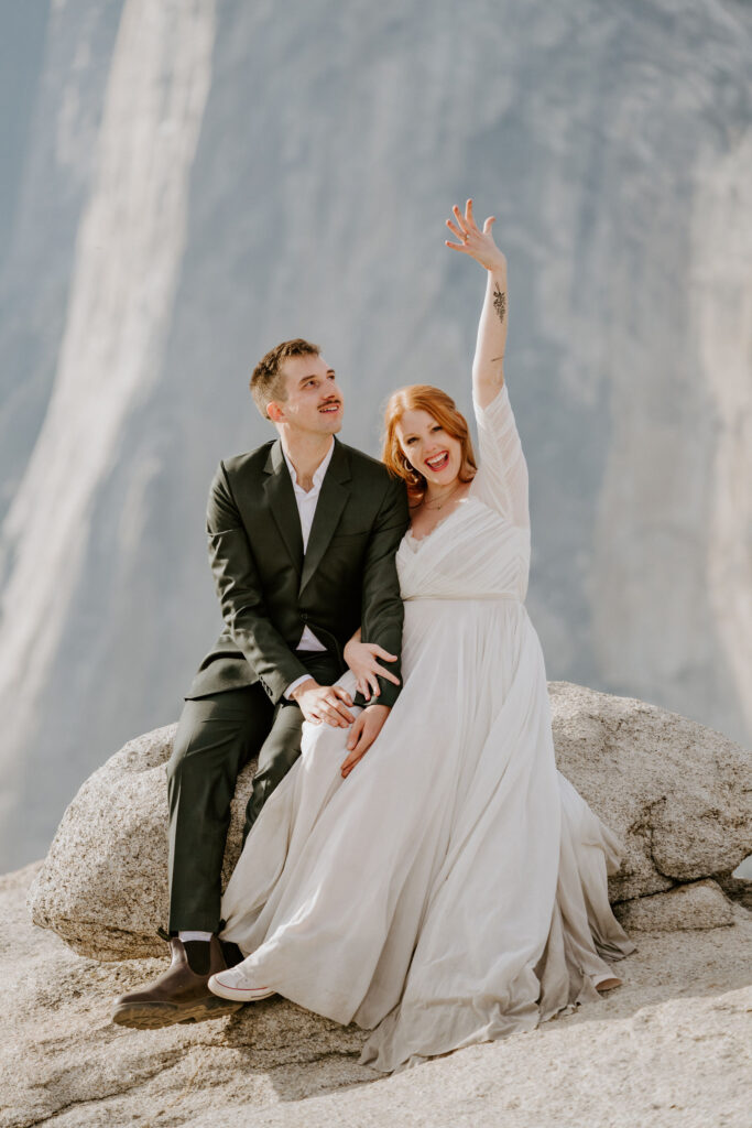 couple cheering after getting married at Taft Point in Yosemite