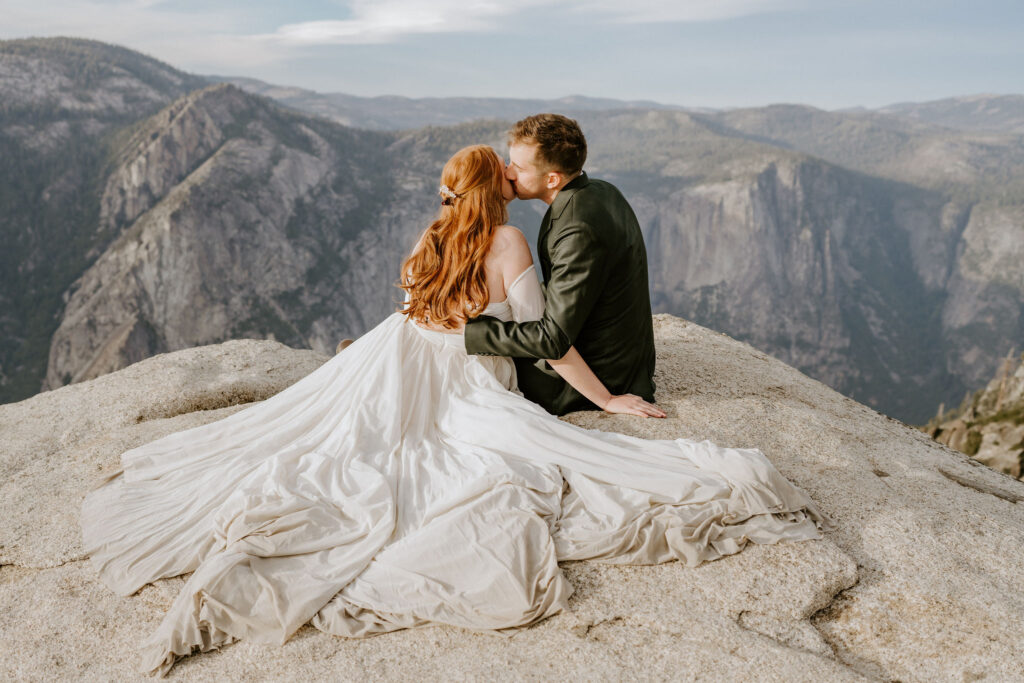 Bride and Groom sitting at Taft Point at sunset