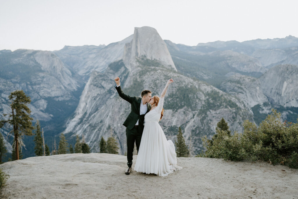 couple cheering after yosemite wedding