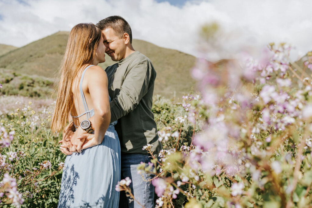 couple surrounded by wildflowers in garrapata state park