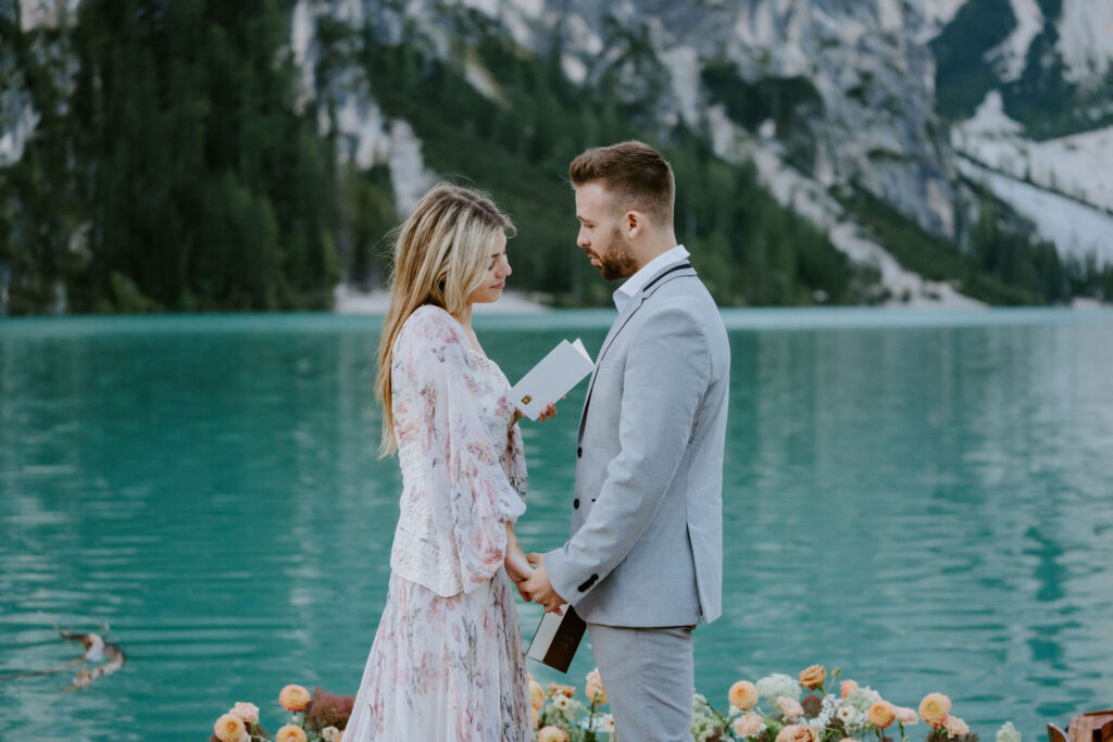 lago di braies elopement ceremony on a wooden dock with alpine mountain views