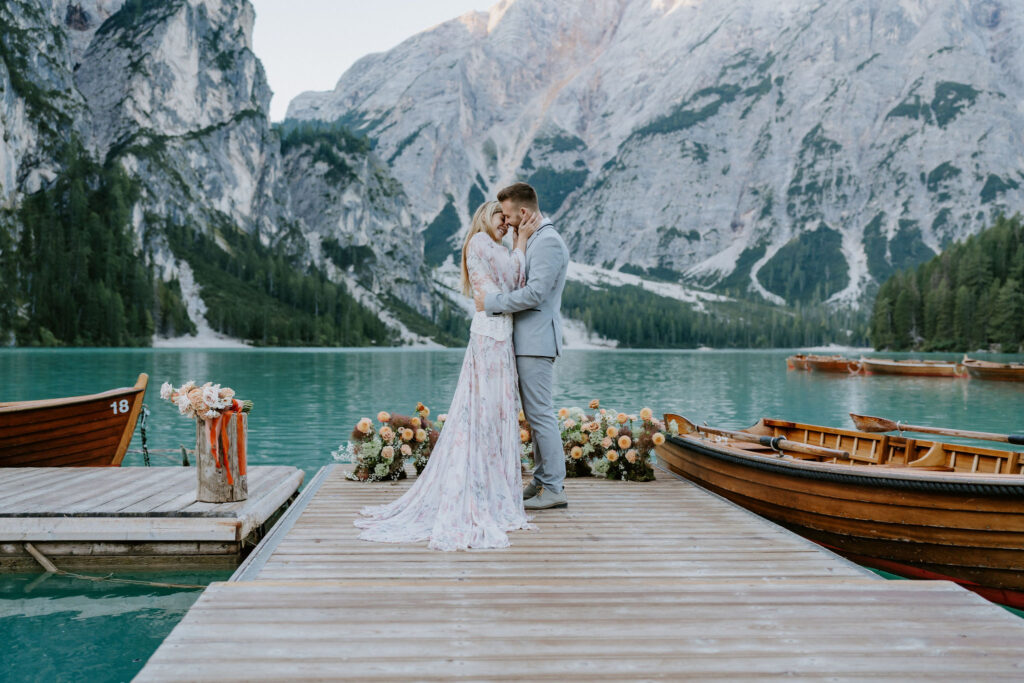 lago di braies elopement ceremony on a wooden dock with alpine mountain views