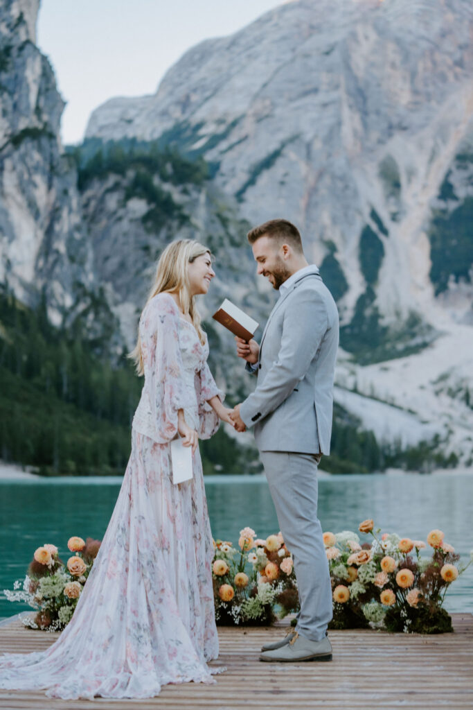 lago di braies elopement ceremony on a wooden dock with alpine mountain views