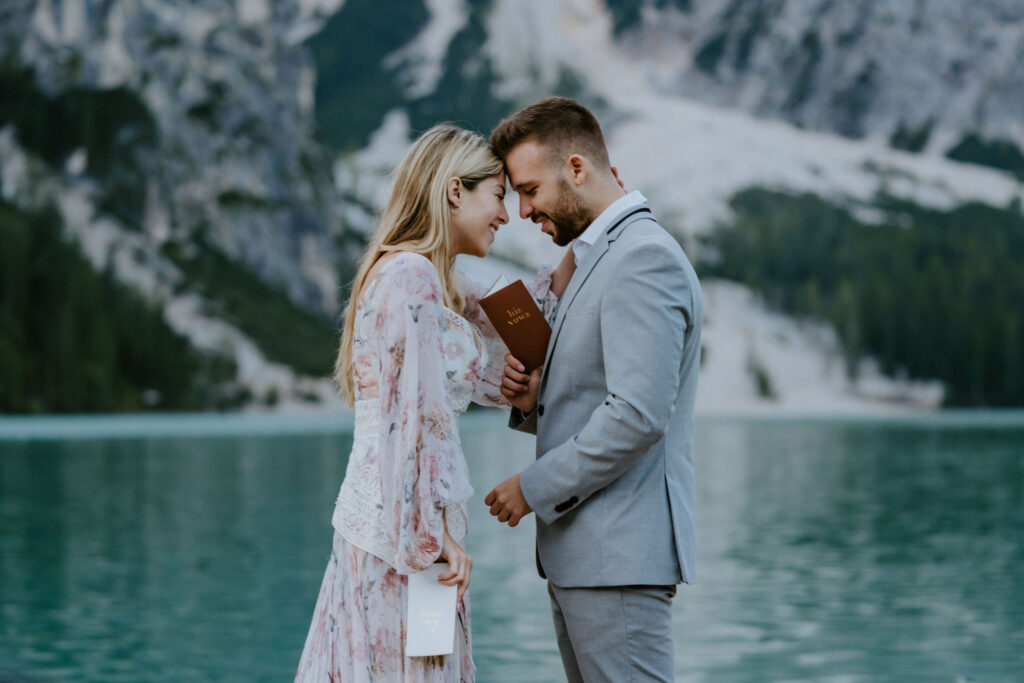 lago di braies elopement ceremony on a wooden dock with alpine mountain views