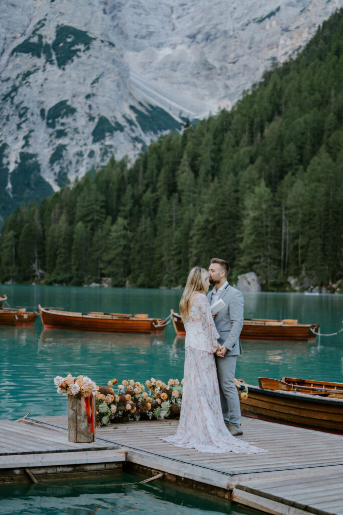 lago di braies elopement ceremony on a wooden dock with alpine mountain views