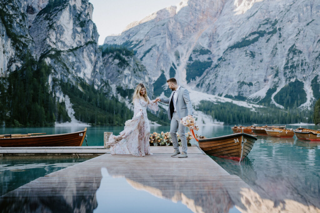 dreamy elopement couple on a wooden dock at lago di braies