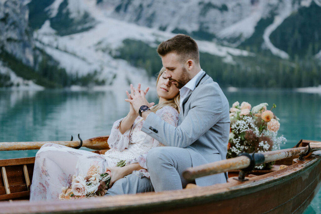 dreamy elopement couple on a classic rowboat in lago di braies