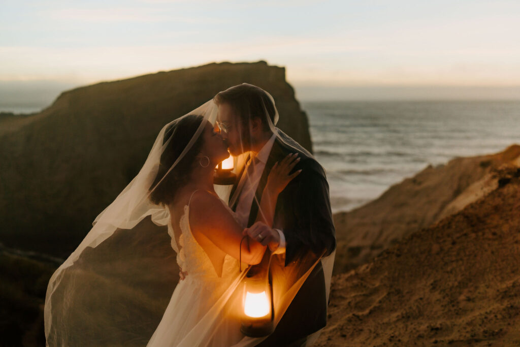 cannon beach elopement couple with lanterns