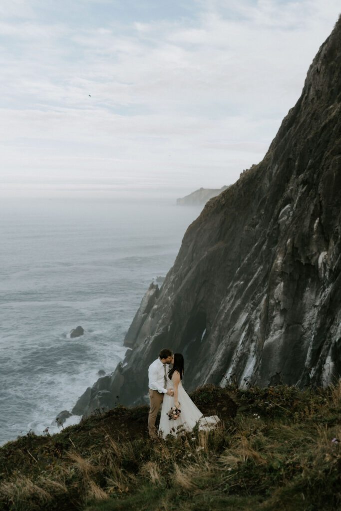 dramatic cannon beach elopement with ocean views and cliffs in the backdrop